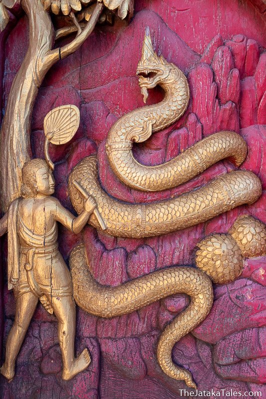 woodcarving of naga coiled around an anthill